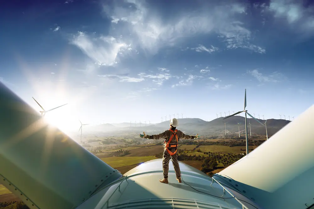 Technician standing on a wind turbine