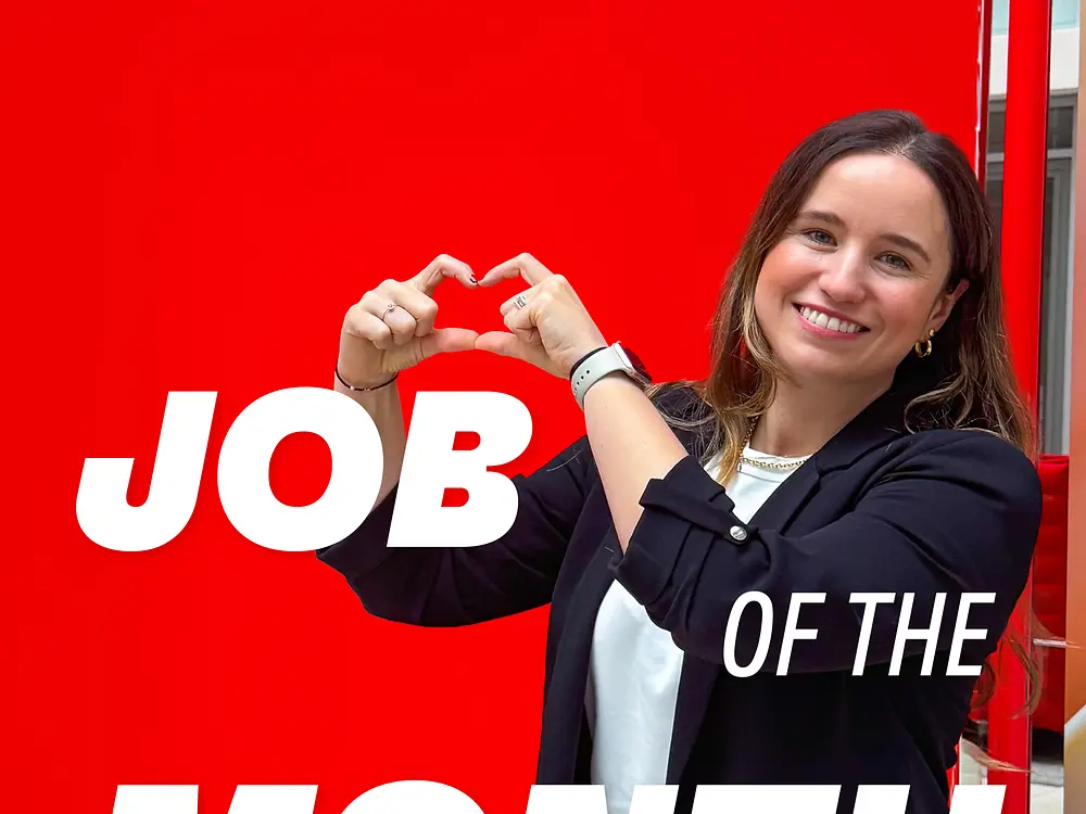 Employee forming heart shape with hands against red background with text Job of the Month: M&A Tax Manager